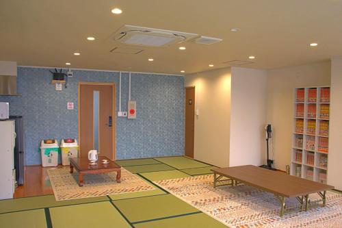 a living room with a table and a table sidx sidx at オレンジの風 in Imabari