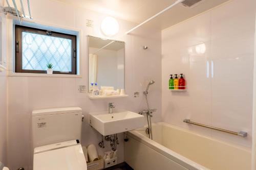 a bathroom with a toilet and a sink and a shower at 臨空の宿 MARUYA Izumisano in Izumi-Sano