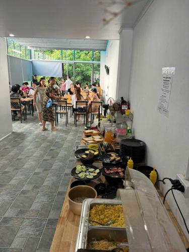 a buffet line with plates of food in a room at Sapa Grand Blue Hotel in Sa Pa