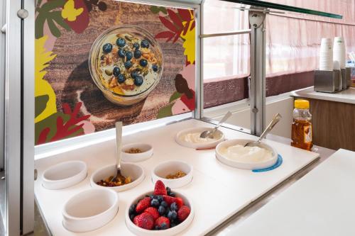 a buffet with bowls of food and fruit on a counter at Element Lexington in Lexington