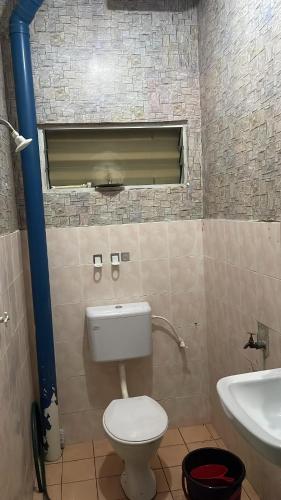a bathroom with a toilet and a sink at Lylinz Dy Cermai in Pasir Gudang