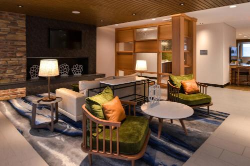 a lobby with couches and a table and chairs at Fairfield Inn & Suites by Marriott Columbus Grove City in Grove City