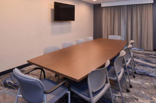 a conference room with a wooden table and chairs at Fairfield Inn & Suites by Marriott Columbus Grove City in Grove City