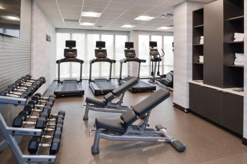 a gym with several rows of exercise bikes and weights at Fairfield Inn & Suites by Marriott Columbus Grove City in Grove City