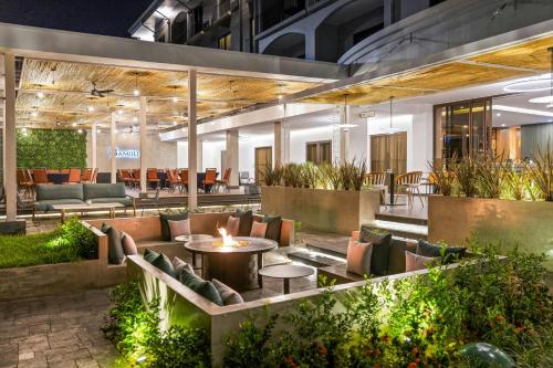 a lobby of a building with couches and a fire pit at Courtyard by Marriott San Jose Escazu in San José