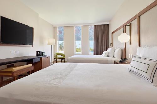 a hotel room with a large bed and a desk at Fairfield Inn & Suites by Marriott Cancun Airport in Cancún
