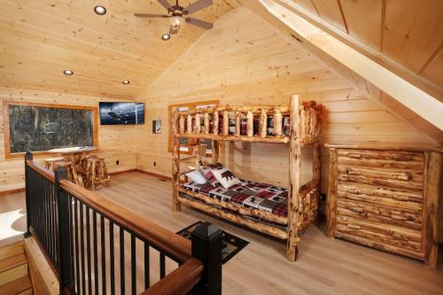 a bedroom in a log cabin with a bunk bed at Chestnut Tower in Gatlinburg