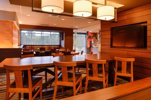a conference room with a large wooden table and chairs at Fairfield Inn & Suites by Marriott Plymouth White Mountains in Plymouth