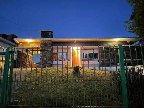 a house with a fence in front of it at Casa con piscina Atlántida in Atlántida