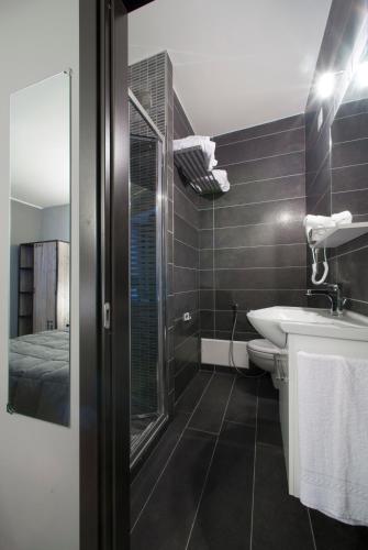 a bathroom with a shower and a sink and a toilet at Il Taschino Suite in Naples