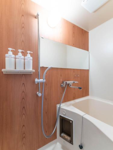 a shower in a bathroom with a sink and a bath tub at 心斎橋梅田京都usjなど人気観光エリアへアクセス抜群4ベットルーム3階建て貸切 in Osaka