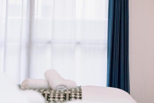 a room with a window with blue curtains at Nihonbashi Royal in Osaka