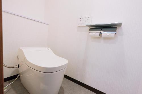 a bathroom with a white toilet in a stall at Nihonbashi Royal in Osaka