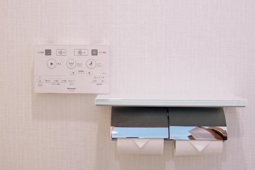 a close up of a paper towel dispenser on a wall at Nihonbashi Royal in Osaka