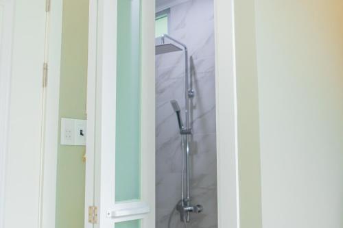a shower is shown through a glass door at Camellia Full House in Da Nang