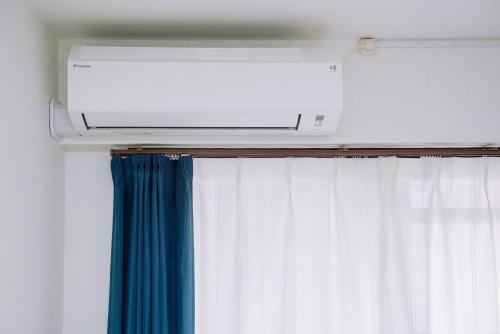 a air conditioner on top of a window at Nihonbashi Royal in Osaka