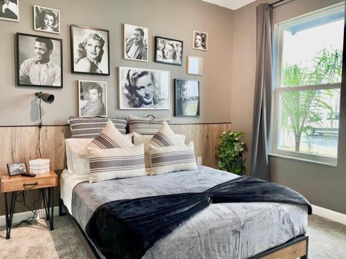 a bedroom with a large bed with pictures on the wall at Luxury 6 Bedroom 5 bath poolHome 214 in Orlando