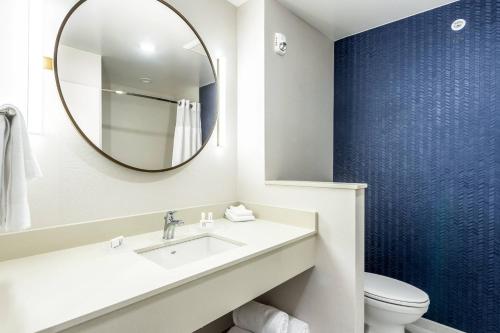 a bathroom with a sink and a mirror at Fairfield Inn & Suites by Marriott Dallas DFW Airport North Coppell Grapevine in Coppell