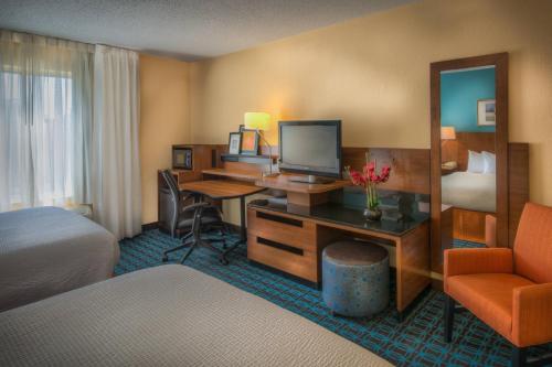 a hotel room with a desk with a computer and a bed at Fairfield Inn Richmond Chester in Chester