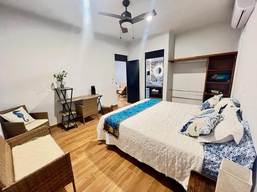 a bedroom with a bed and a desk in it at Casitas Punta Arenas #3 in La Ventana
