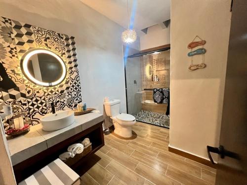 a bathroom with a toilet and a sink and a mirror at Casitas Punta Arenas #3 in La Ventana