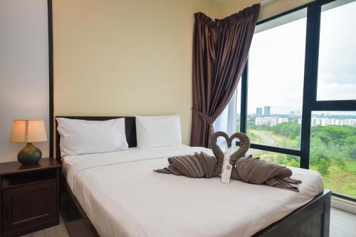 a bedroom with two beds and a large window at Midvalley Southkey Mosaic Suite by Nest Home in Johor Bahru
