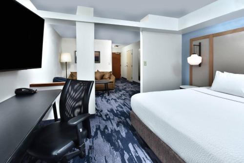 a hotel room with a bed and a desk at Fairfield Inn & Suites by Marriott Richmond Innsbrook in Richmond