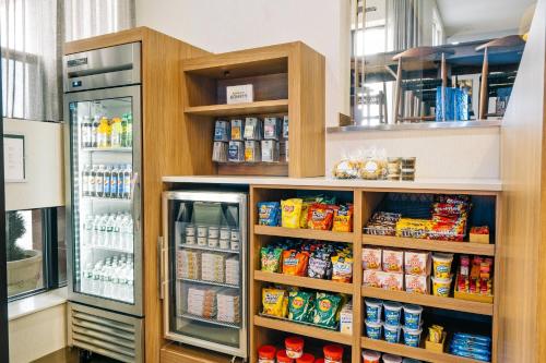 a refrigerator and shelves with food in a store at Fairfield Inn by Marriott New York LaGuardia Airport/Astoria in Queens