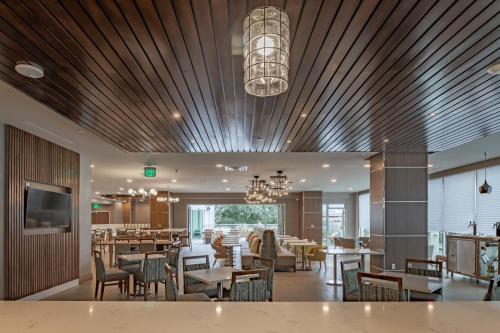 a restaurant with tables and chairs and a chandelier at Element Dallas Downtown East in Dallas