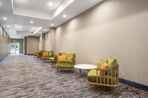 a row of chairs and tables in a waiting room at Fairfield Inn & Suites by Marriott Dallas Plano/Frisco in Plano