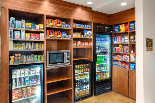 a room with a refrigerator and a tv in it at Fairfield Inn & Suites by Marriott Dallas Downtown in Dallas