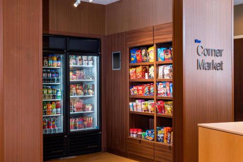 a room with two refrigerators with food and drinks at Fairfield by Marriott Inn & Suites Palm Desert Coachella Valley in Palm Desert