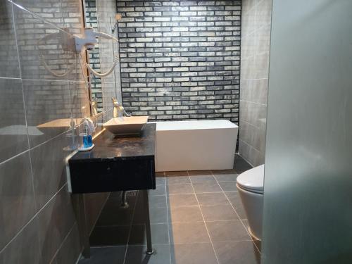 a bathroom with a sink and a bath tub at Karak Tourist Hotel in Seoul