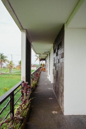 a hallway of a building next to a fence at Swell Hotel, Pool Bar & Restaurant in Tanah Lot