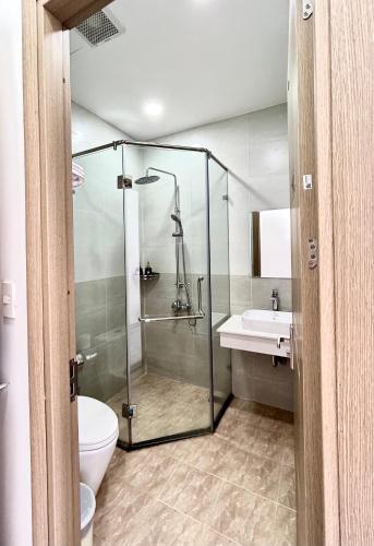 a bathroom with a shower and a toilet and a sink at Coconut Hotel in Phú Quốc