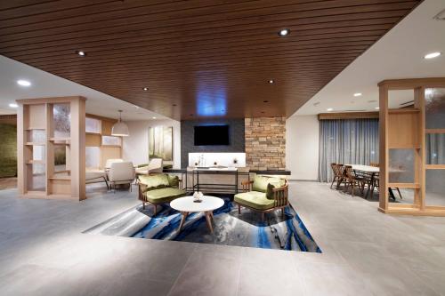 a lobby with a living room and a dining room at Fairfield Inn & Suites by Marriott Dayton North in Murlin Heights
