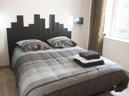 a bedroom with a large bed with a black headboard at Maison de Ville avec Spa et Sauna près d'Orléans - FR-1-590-547 in Chécy