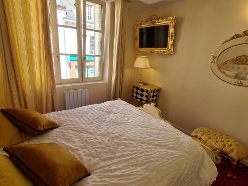 a bedroom with a large white bed with a window at Appartement Délire Baroque à Sully-sur-Loire avec Climatisation - FR-1-590-557 in Sully-sur-Loire