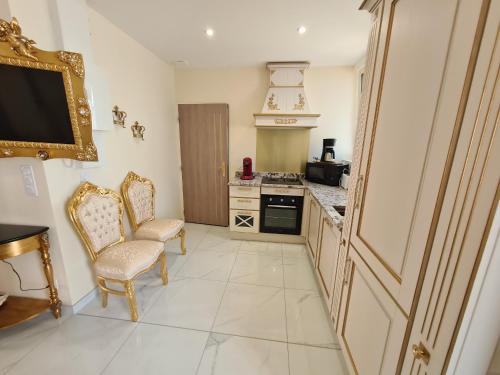 a kitchen with a table and two chairs and a television at Appartement Délire Baroque à Sully-sur-Loire avec Climatisation - FR-1-590-557 in Sully-sur-Loire