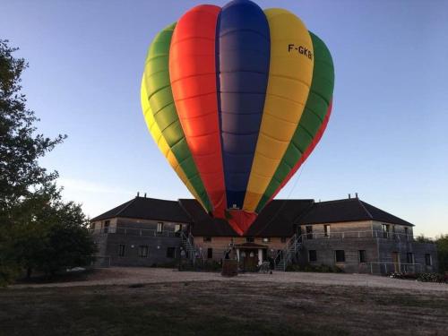 a colorful hot air balloon in front of a building at Gîte en Sologne avec loisirs et activités proches - FR-1-590-554 in Jouy-le-Potier
