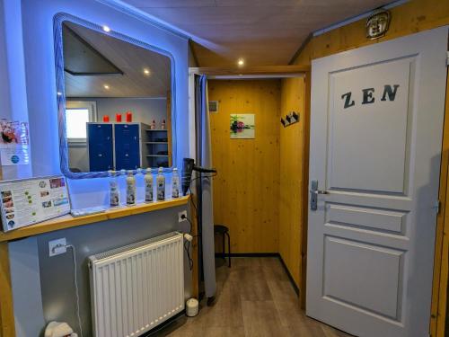 a door leading into a room with a bar and a room with at Yourte atypique avec sauna et terrasse privative - FR-1-589-765 in Ferdrupt