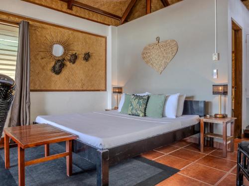 a bedroom with a large bed in a room at Golden Monkey Beach Hotel in El Nido