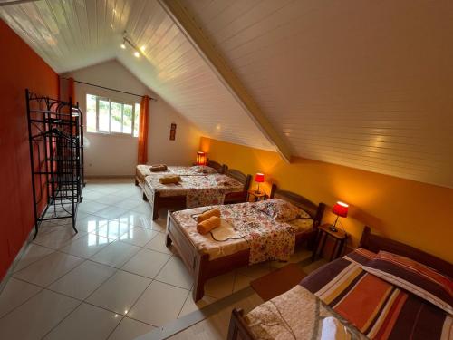 a room with three beds in a room at Gîte 3 épis avec cuisine équipée et centre équestre à proximité - FR-1-786-38 in Saint-Benoît