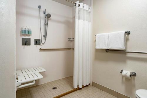 a bathroom with a shower and a toilet at Courtyard Tampa Westshore/Airport in Tampa