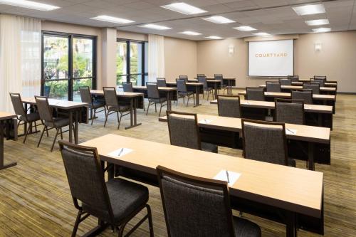 a classroom with tables and chairs and a whiteboard at Courtyard Tampa Westshore/Airport in Tampa