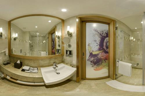 a bathroom with a sink and a large mirror at Fairfield by Marriott Lucknow in Lucknow