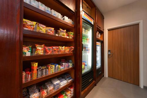 a store aisle with a refrigerator filled with food at Fairfield Inn Arlington Near Six Flags in Arlington