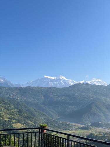 a balcony with a view of a mountain range at Barang Village Community Homestay in Pokhara