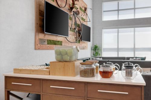 a kitchen with a counter with a tv on the wall at Element New York Wood Ridge in Wood-Ridge