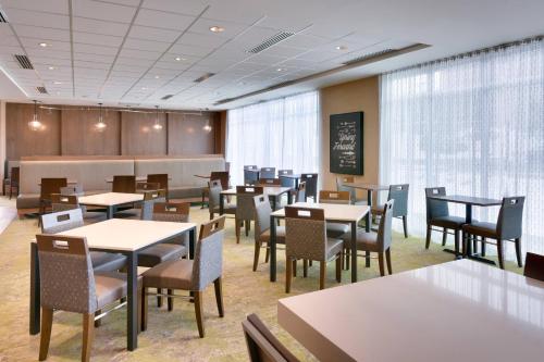 a dining room with tables and chairs and a chalkboard at Fairfield Inn & Suites by Marriott Denver West/Federal Center in Lakewood